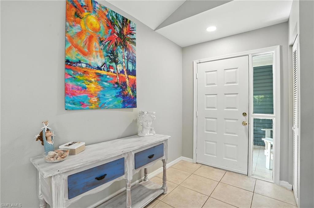 3380 Timberwood Circle Naples, FL 34105 - Photo 13 of 38 a room with painting and a table