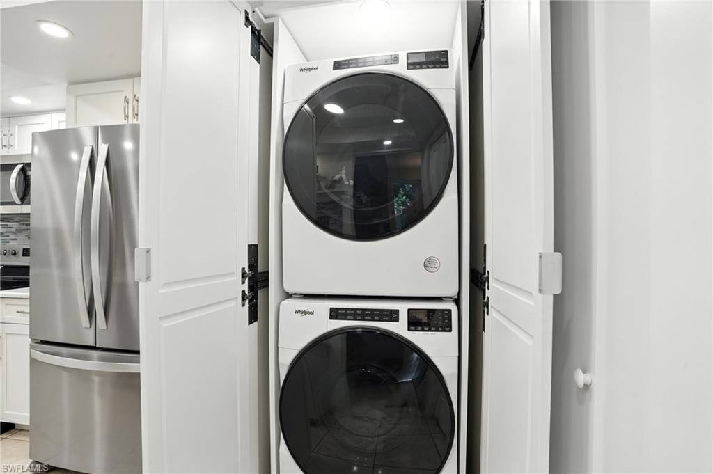 3380 Timberwood Circle Naples, FL 34105 - Photo 26 of 38 a utility room with dryer and washer