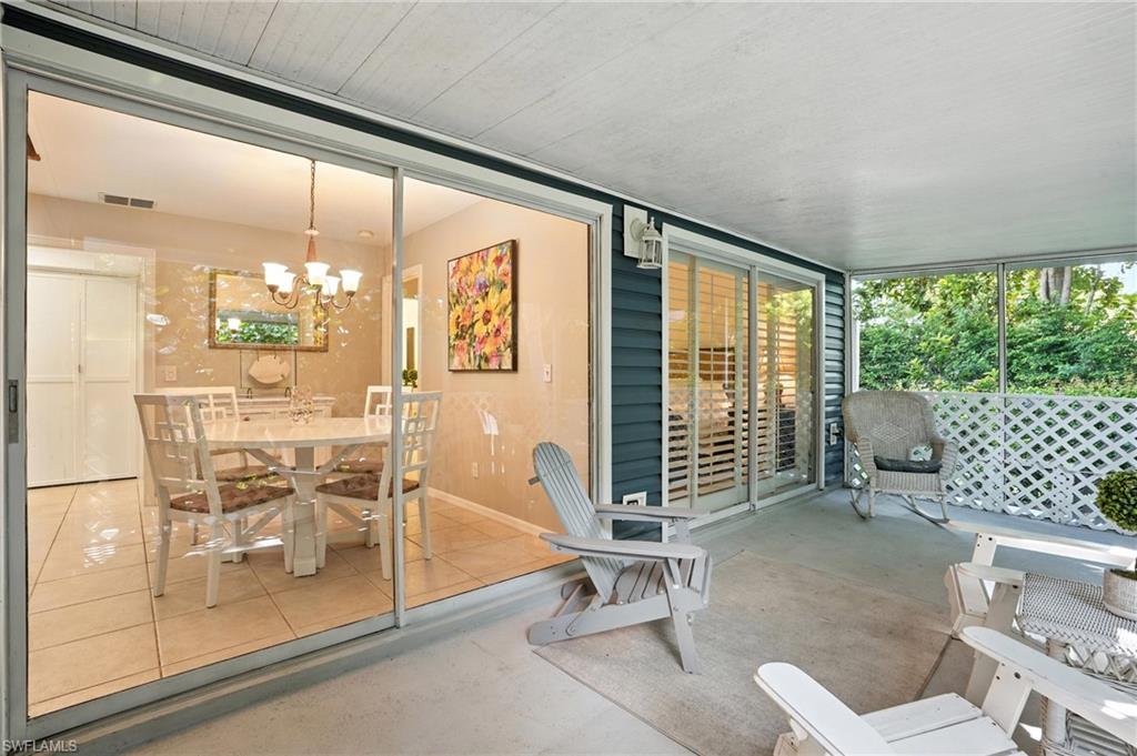3380 Timberwood Circle Naples, FL 34105 - Photo 29 of 38 a dining room with furniture and a floor to ceiling window