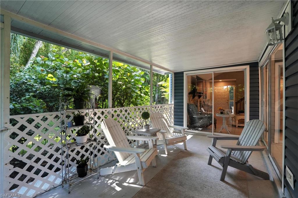 3380 Timberwood Circle Naples, FL 34105 - Photo 30 of 38 a living room with furniture and a large window