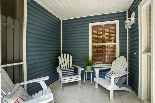 a view of back yard of the house with outdoor seating
