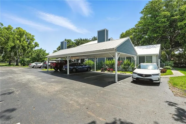 a view of a white house with a yard and balcony
