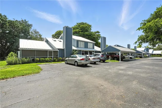 a couple of cars parked in front of a house