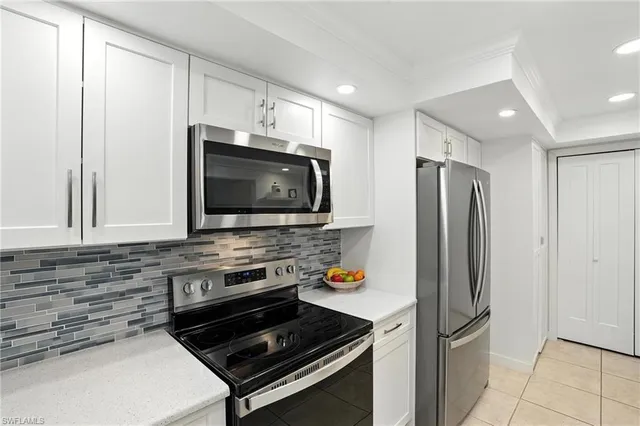 a kitchen with stainless steel appliances a stove a microwave and a refrigerator