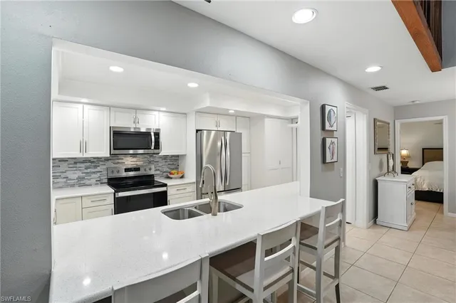 a kitchen with stainless steel appliances a refrigerator and a stove top oven