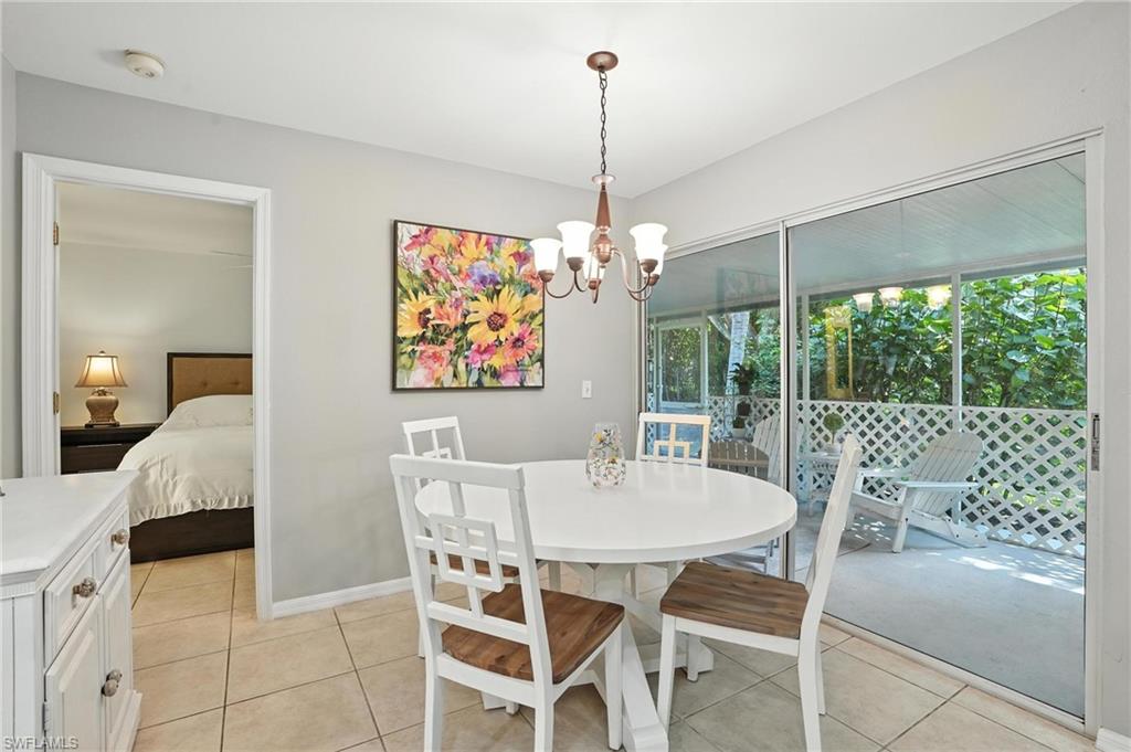 3380 Timberwood Circle Naples, FL 34105 - Photo 9 of 38 a view of a dining room and furniture window and outside view