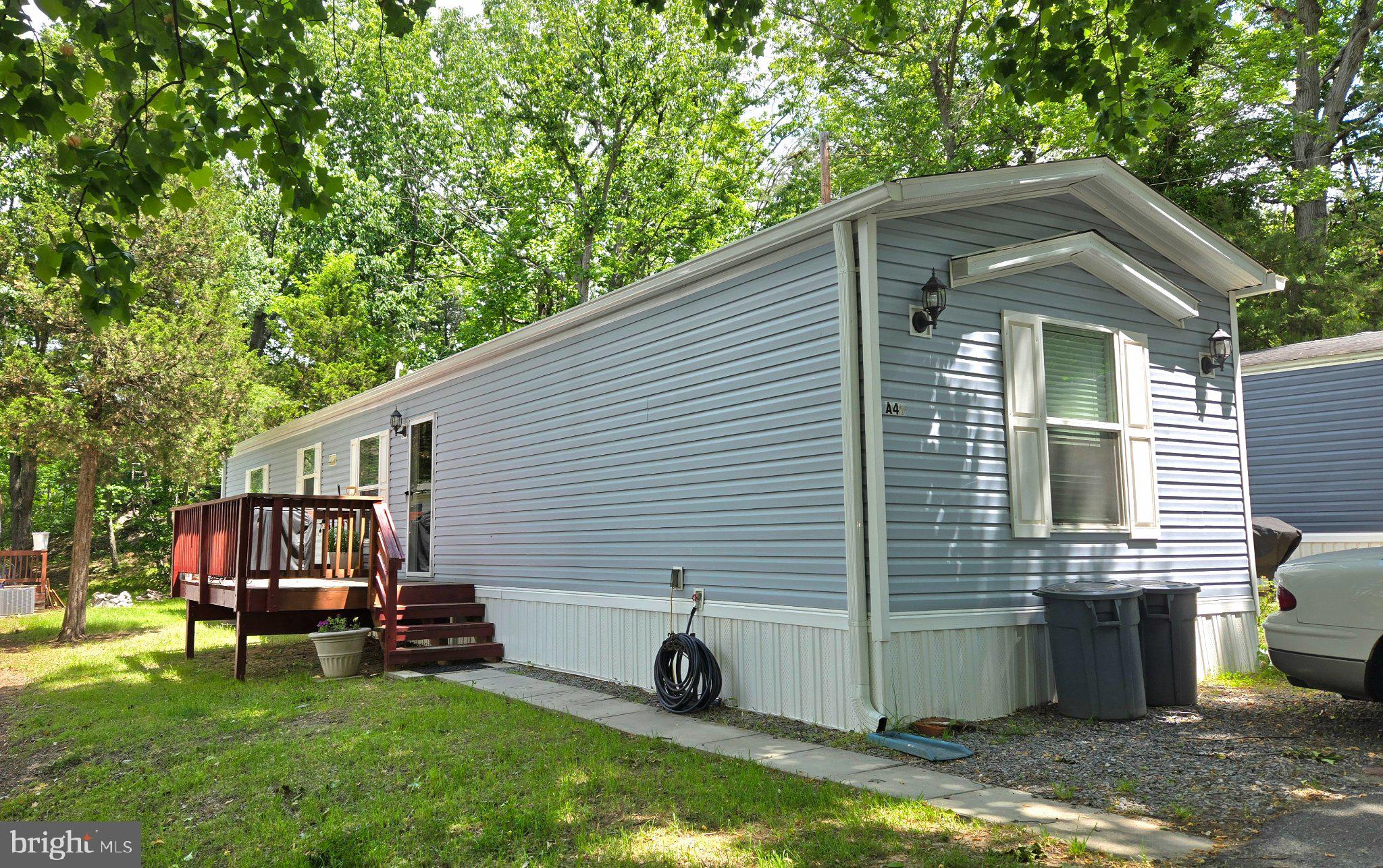 7810 Clark Road, Unit A49 Jessup, MD 20794 - Photo 2 of 26 Charming blue home in a serene setting.
