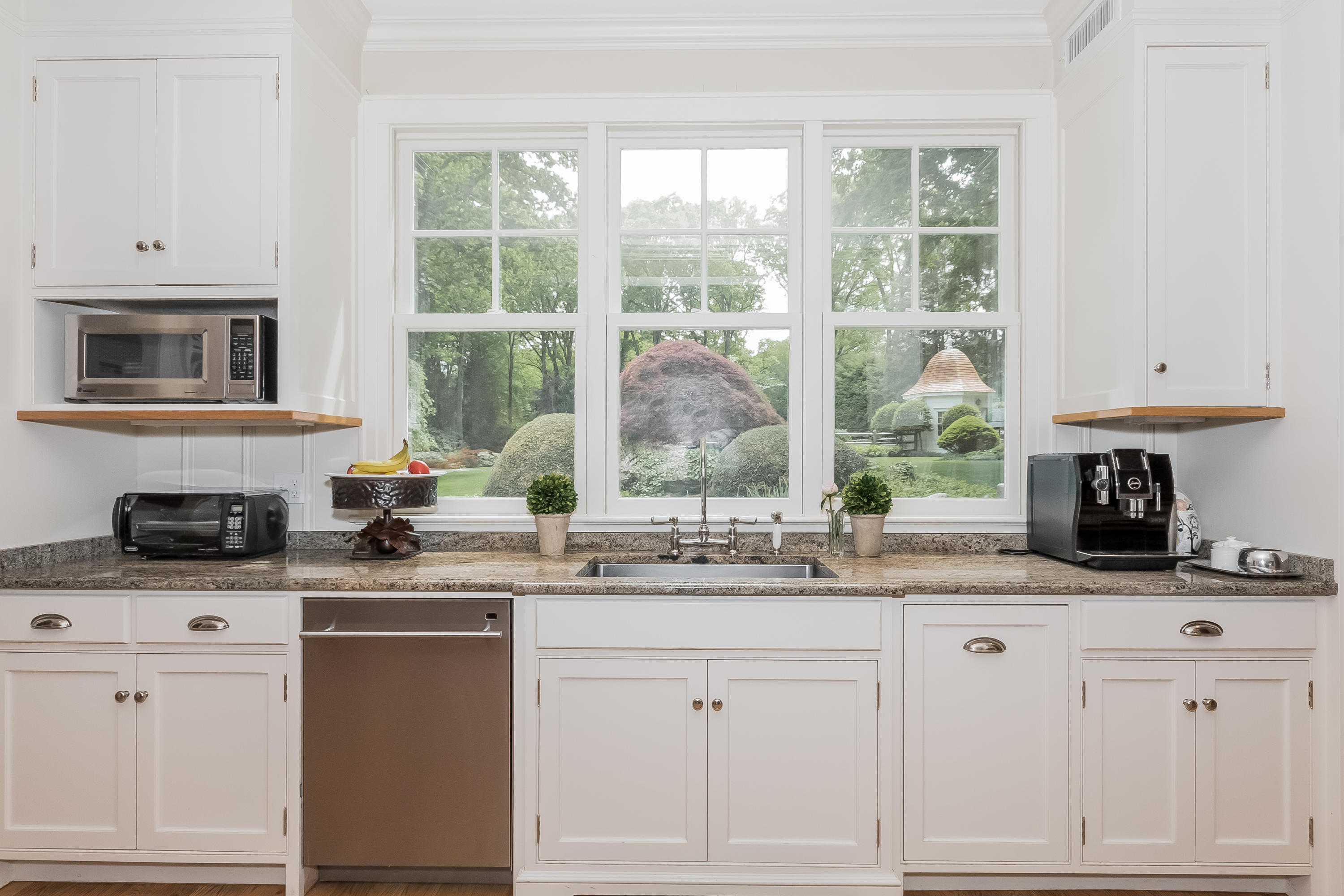370 Wahackme Road New Canaan, CT 06840 - Photo 13 of 35 a kitchen with granite countertop white cabinets and white appliances
