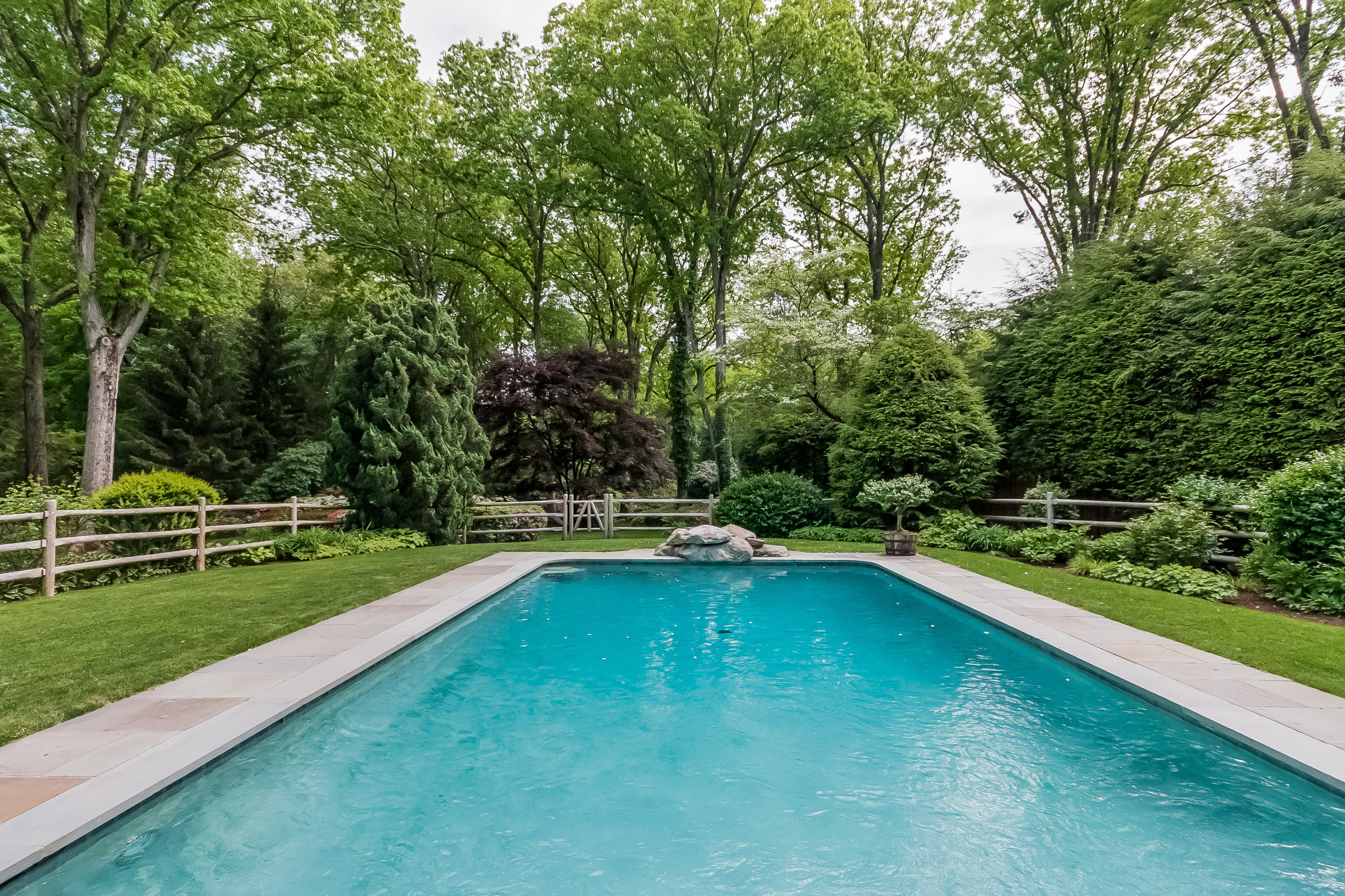 370 Wahackme Road New Canaan, CT 06840 - Photo 24 of 35 a view of a swimming pool with a yard