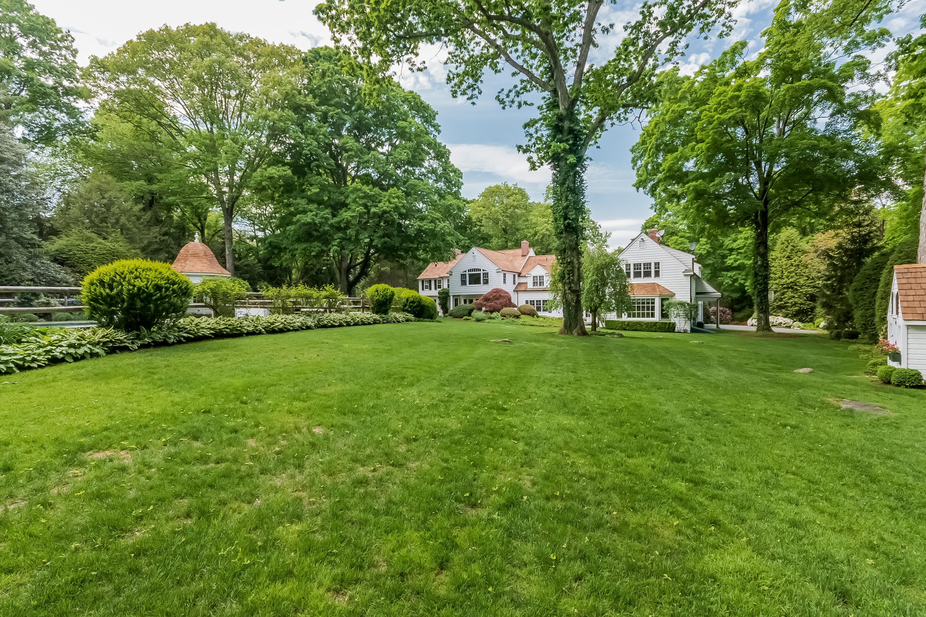 370 Wahackme Road New Canaan, CT 06840 - Photo 28 of 35 a view of a green field with trees in the background