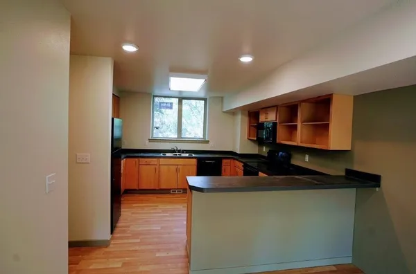 a kitchen with a sink and a mirror