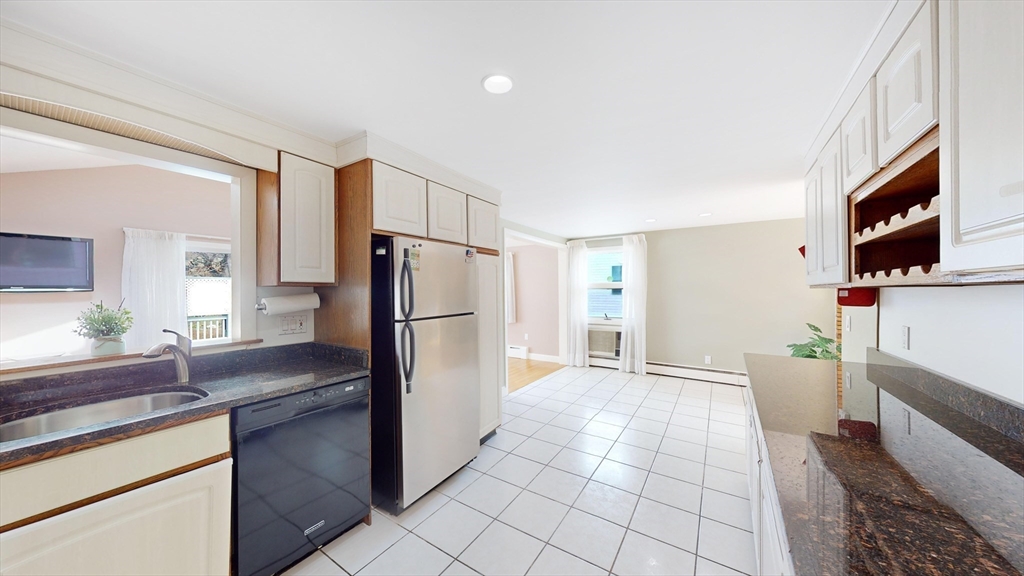 8 Stone Road Arlington, MA 02474 - Photo 6 of 26 a kitchen with granite countertop a refrigerator and a sink