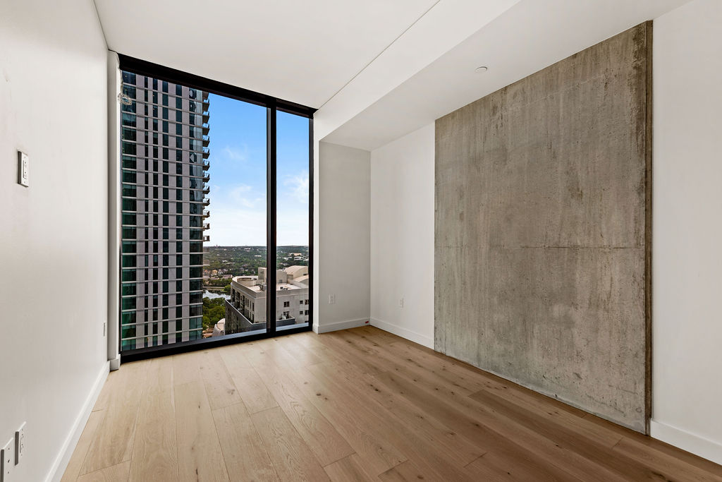 610 Davis Street, Unit 2504 Austin, TX 78701 - Photo 9 of 28 a view of an empty room with wooden floor and a window