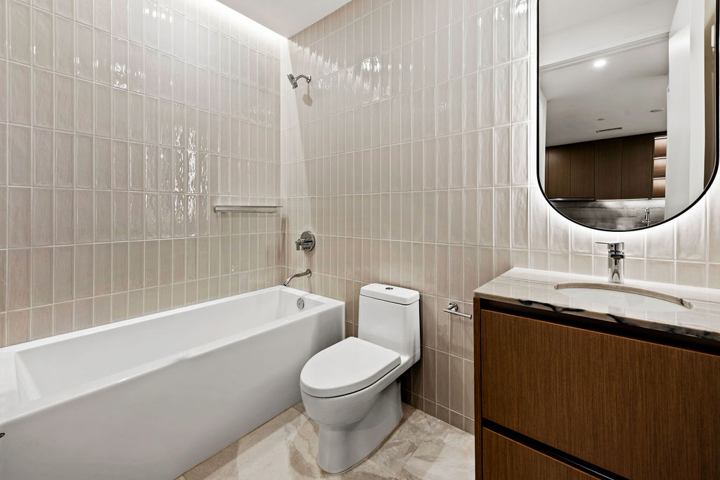 610 Davis Street, Unit 2504 Austin, TX 78701 - Photo 10 of 28 a bathroom with a sink a toilet and bathtub