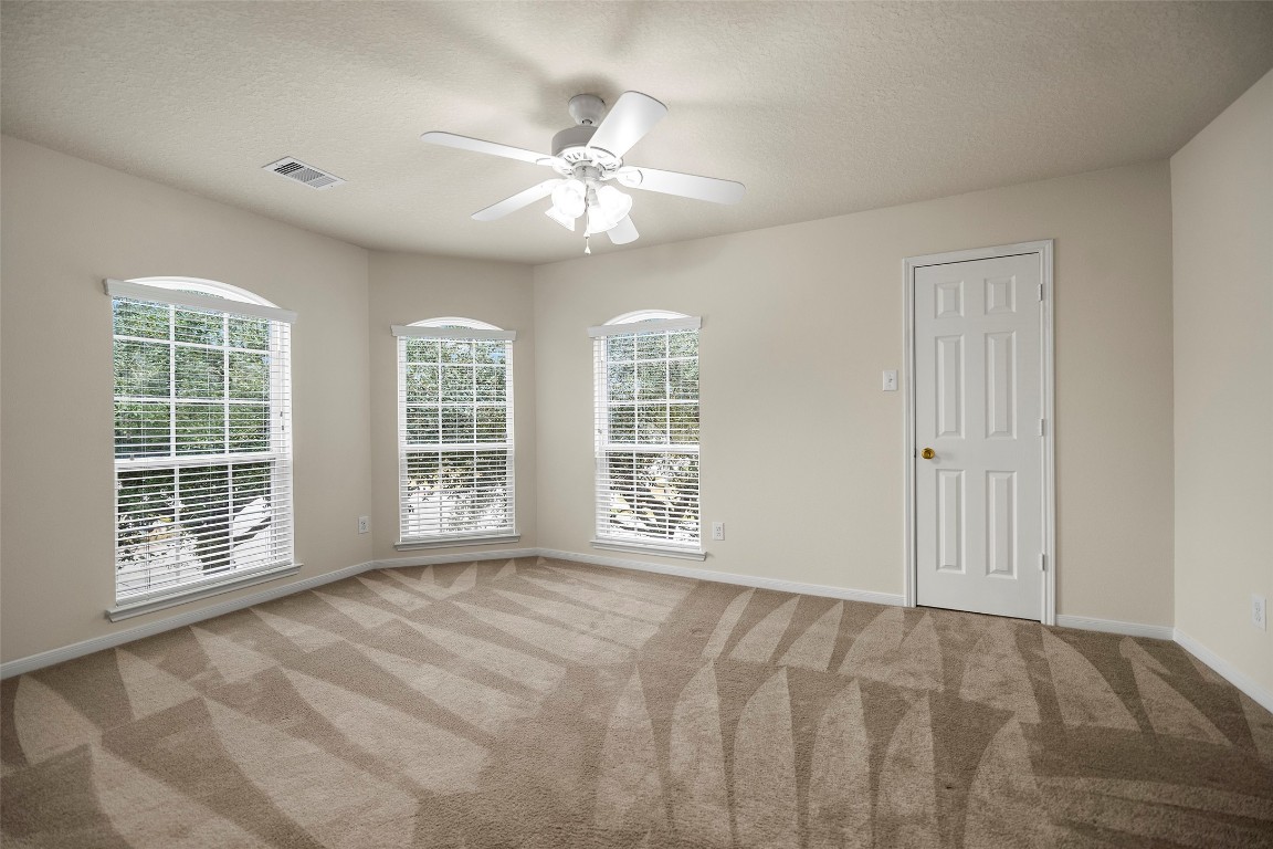 9934 Yearling Place Conroe, TX 77385 - Photo 34 of 47 Bedroom 6. Look at that view. All those windows letting in the morning light