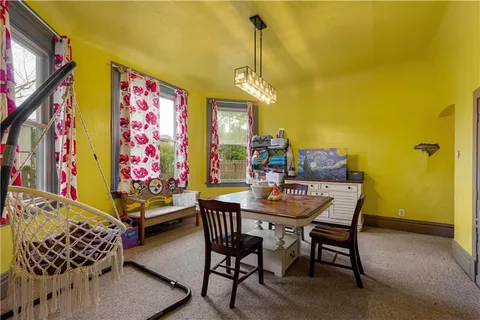a view of a dining room with furniture and chandelier