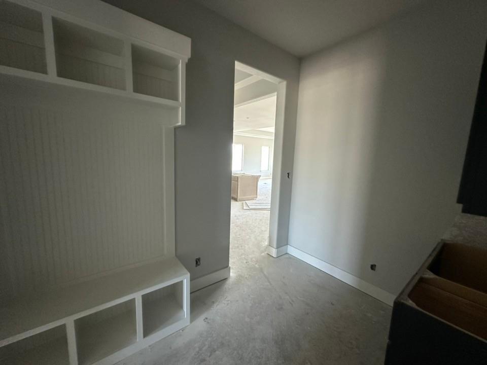 295 Brown Road Leonard, TX 75452 - Photo 13 of 26 Built-in white storage bench with cubbies and upper shelving, beadboard backing, and painted trim
