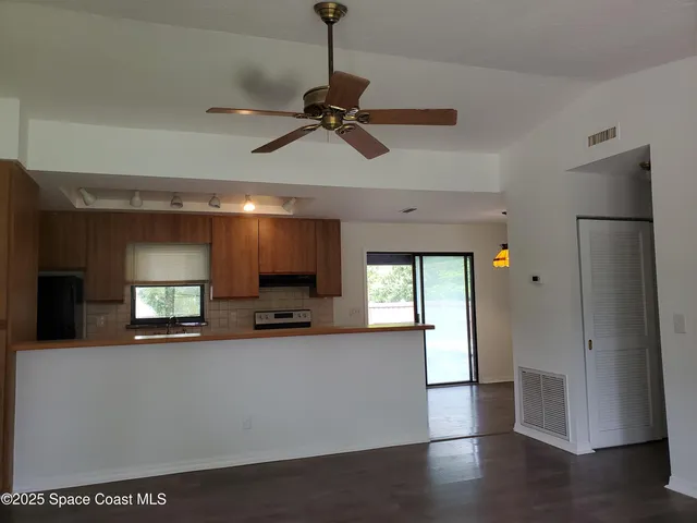 a view of a living room a window and a chandelier