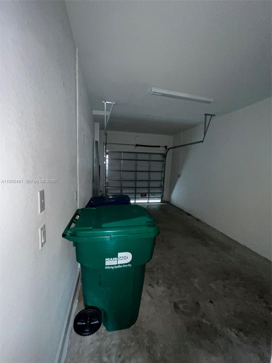 16243 Southwest 289th Street, Unit 16243 Homestead, FL 33033 - Photo 11 of 12 a view of a garage