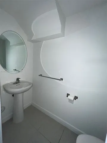 a bathroom with a sink and mirror