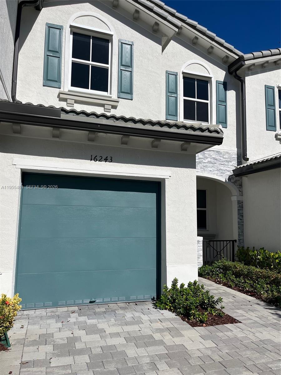 16243 Southwest 289th Street, Unit 16243 Homestead, FL 33033 - Photo 2 of 12 a front view of a house with a yard