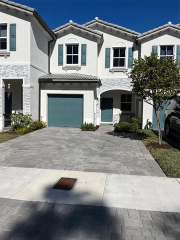 a front view of a house with yard