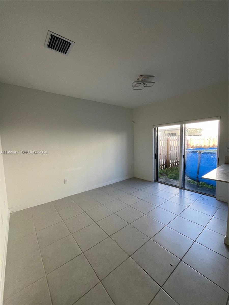 16243 Southwest 289th Street, Unit 16243 Homestead, FL 33033 - Photo 7 of 12 an empty room with a window