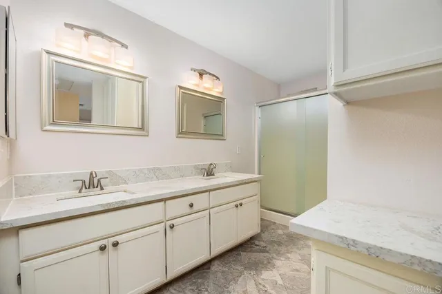 a bathroom with a granite countertop sink mirror and