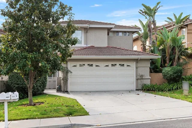a front view of a house with a yard garage and outdoor seating