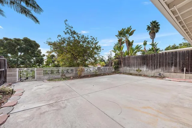 a view of a house with a yard and potted plants