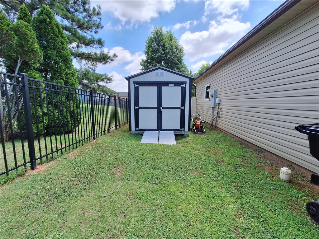 3 Cringle Lane Anderson, SC 29625 - Photo 22 of 26 Secure storage shed with easy ramp access borders a well-maintained lawn.