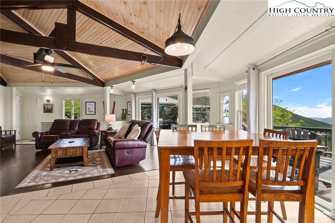 104 Longview Court Seven Devils, NC 28604 - Photo 14 of 46 a living room with furniture a floor to ceiling window and potted plants
