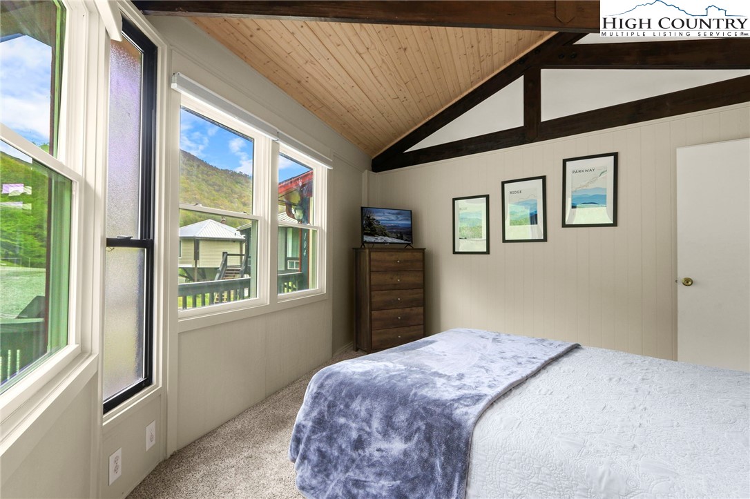 104 Longview Court Seven Devils, NC 28604 - Photo 15 of 46 a bedroom with bed and a large window