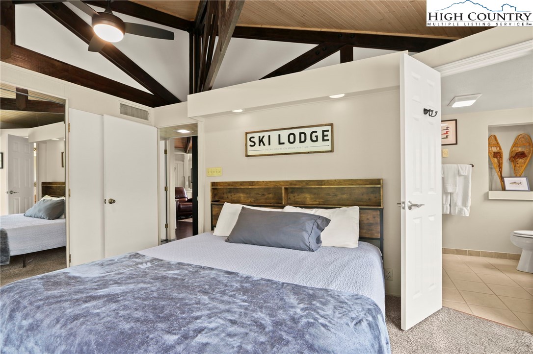 104 Longview Court Seven Devils, NC 28604 - Photo 17 of 46 a bedroom with a bed and couch