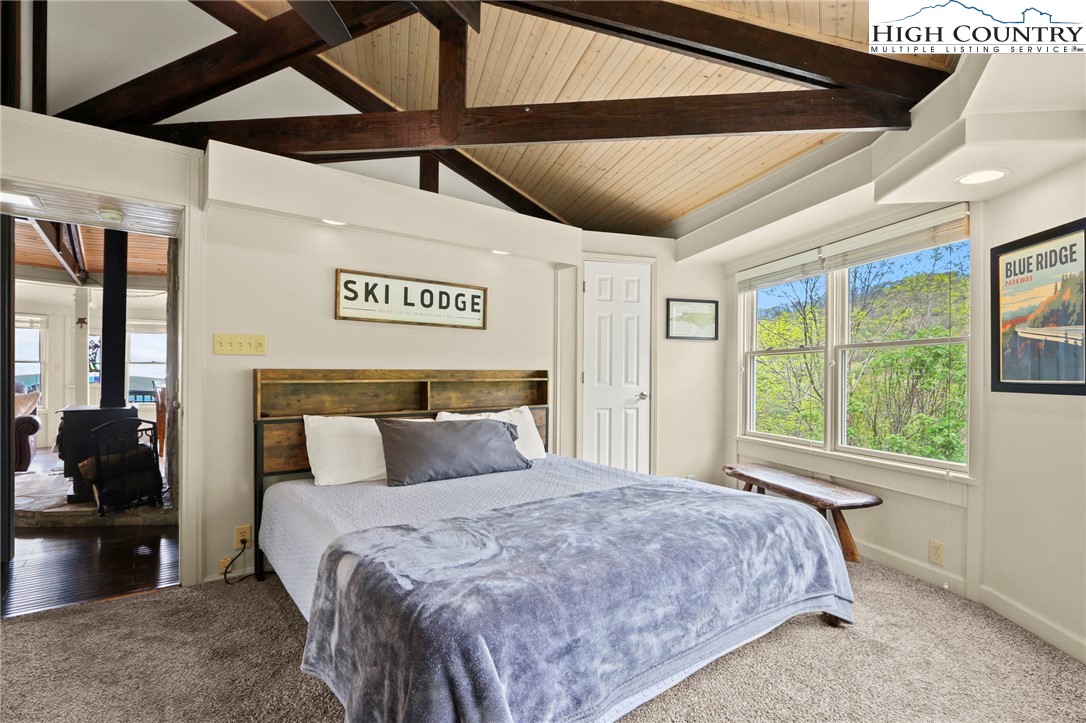 104 Longview Court Seven Devils, NC 28604 - Photo 18 of 46 a bedroom with a large bed and a window