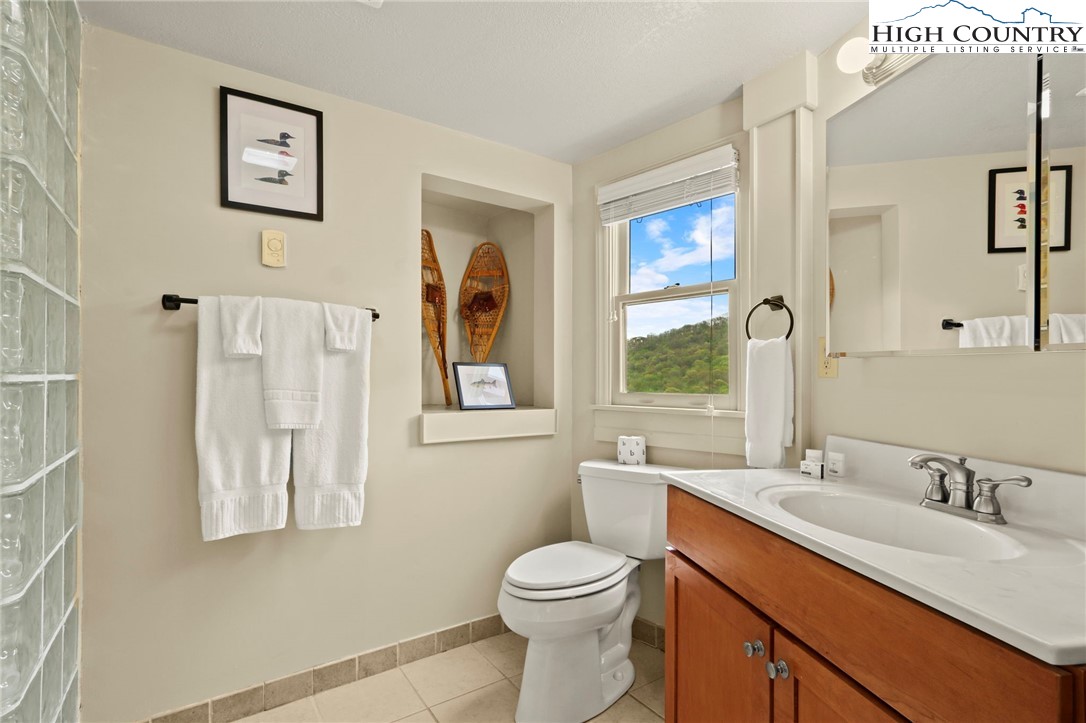 104 Longview Court Seven Devils, NC 28604 - Photo 19 of 46 a bathroom with a toilet sink and mirror