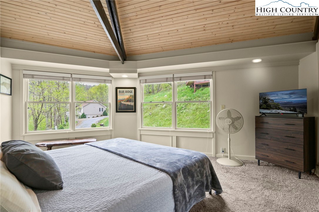 104 Longview Court Seven Devils, NC 28604 - Photo 22 of 46 a bedroom with a bed and a window