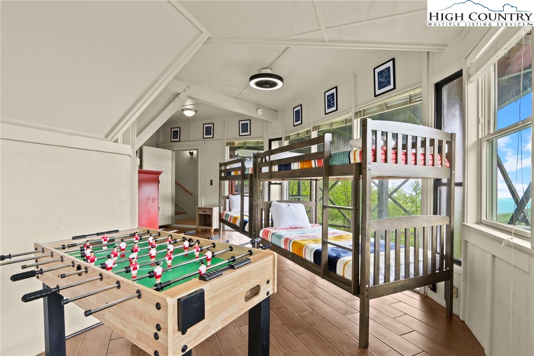 104 Longview Court Seven Devils, NC 28604 - Photo 28 of 46 a bedroom with furniture and a large window