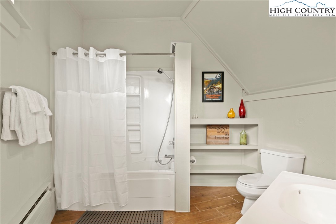 104 Longview Court Seven Devils, NC 28604 - Photo 30 of 46 a bathroom with a shower a toilet and sink