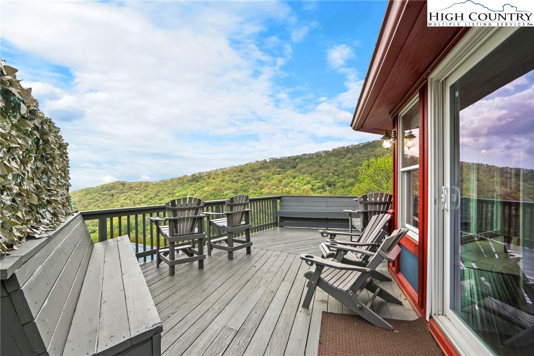 104 Longview Court Seven Devils, NC 28604 - Photo 33 of 46 a view of a chairs and table in patio with a yard