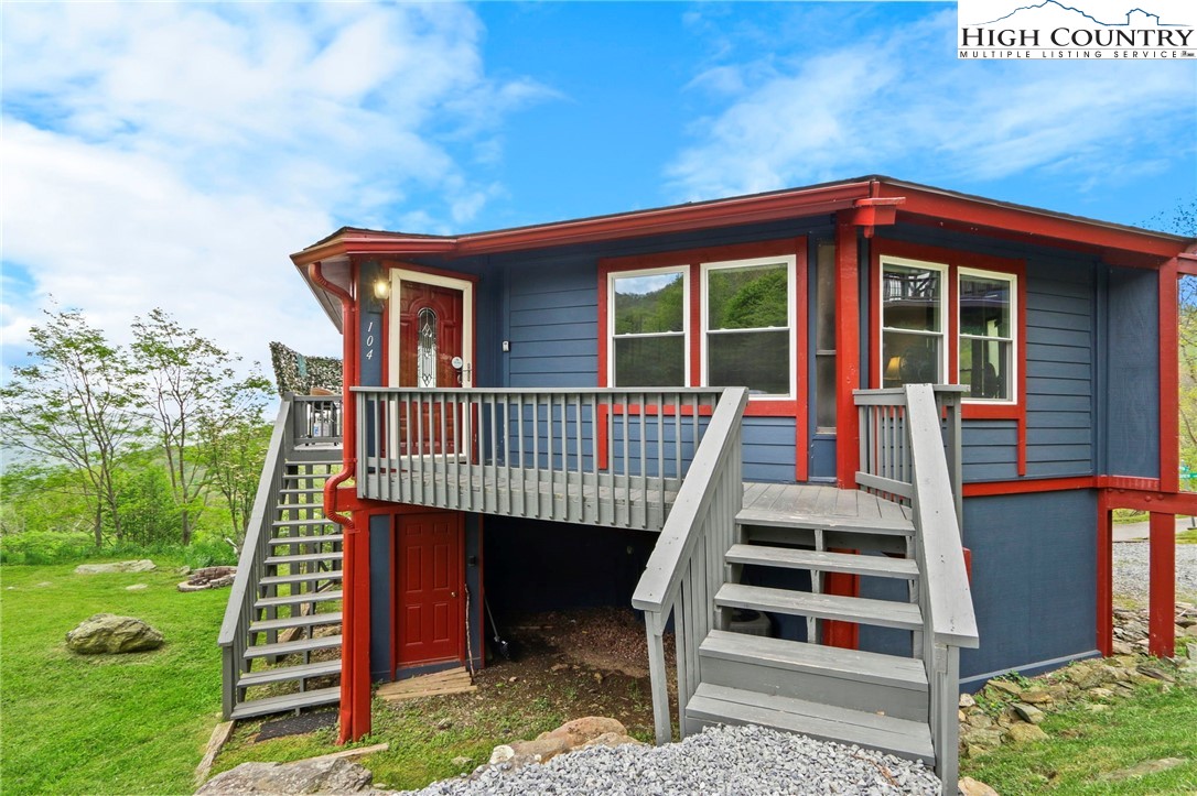 104 Longview Court Seven Devils, NC 28604 - Photo 39 of 46 a view of a house with a deck and a yard