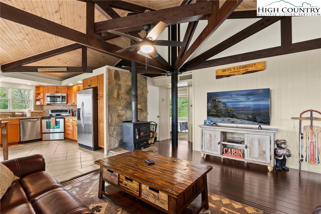 104 Longview Court Seven Devils, NC 28604 - Photo 9 of 46 a living room with furniture and a flat screen tv