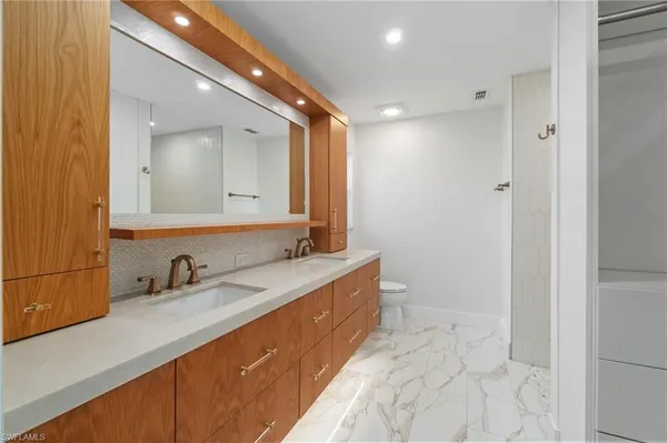 a bathroom with a double vanity sink and a mirror