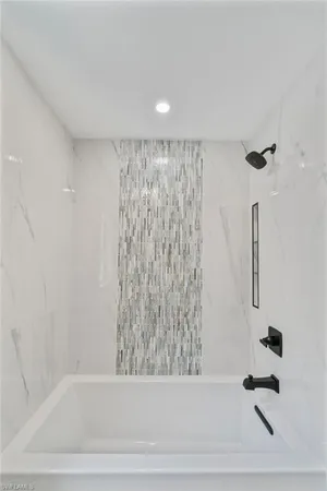a bathroom with a bathtub and shower
