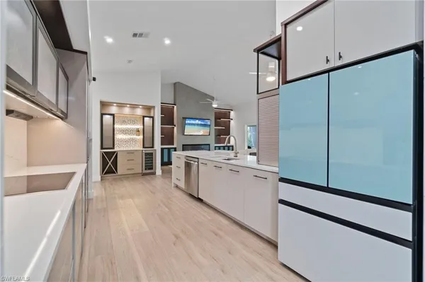 a large kitchen with stainless steel appliances a refrigerator and a stove top oven