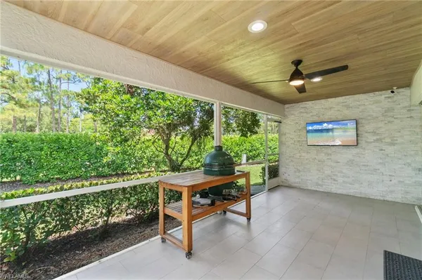 a view of a porch with furniture and a yard