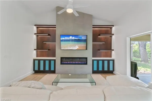 a living room with fireplace furniture and a window