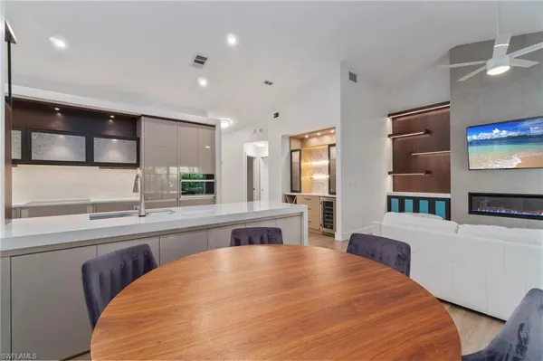 a large kitchen with stainless steel appliances a large counter top