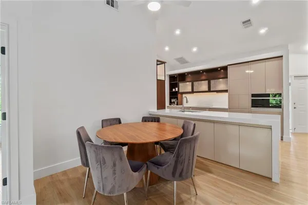 a kitchen with a table and chairs in it