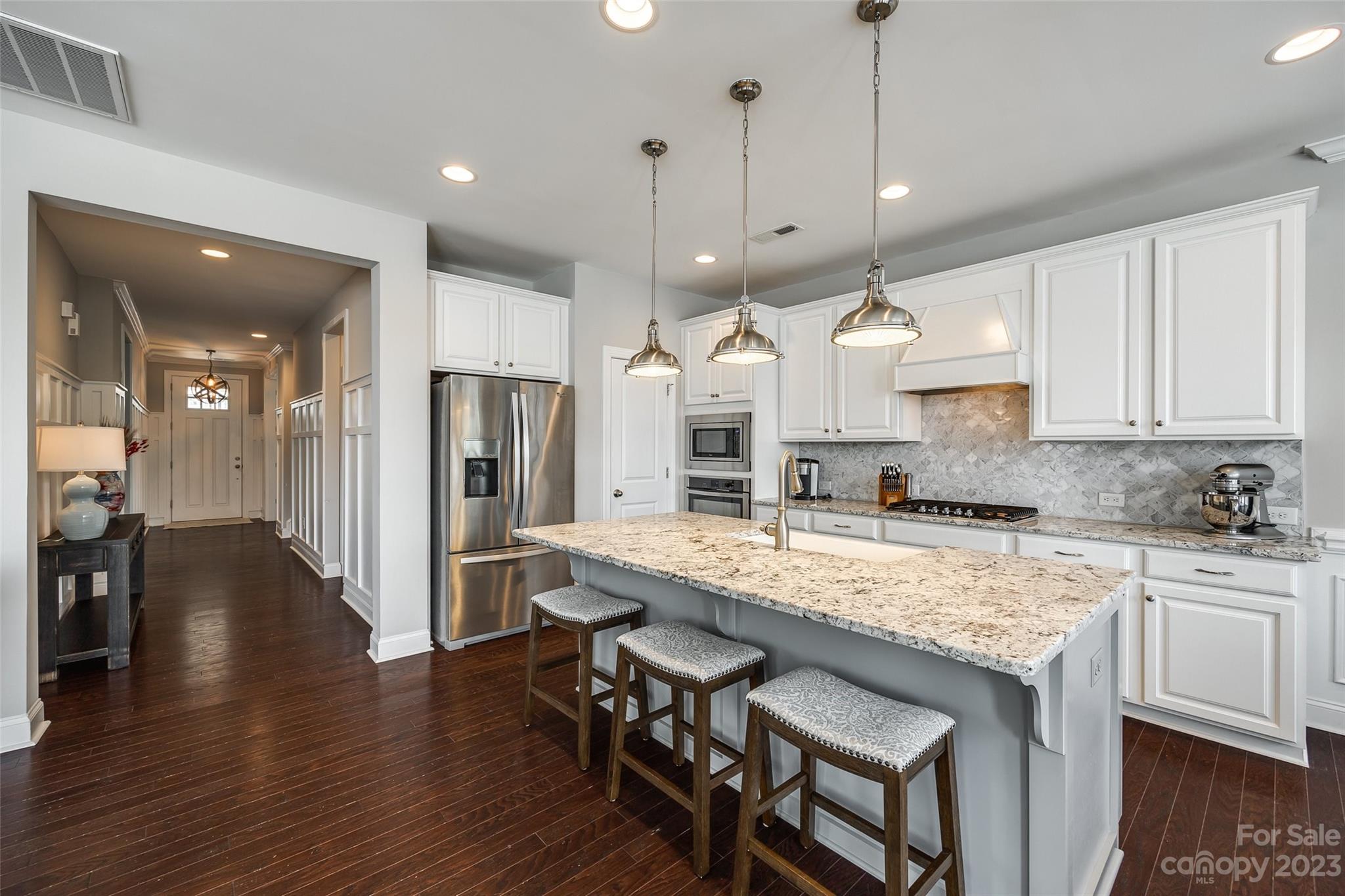 201 Helton Lane Fort Mill, SC 29708 - Photo 17 of 47 a kitchen with stainless steel appliances granite countertop a kitchen island a stove a refrigerator and a sink